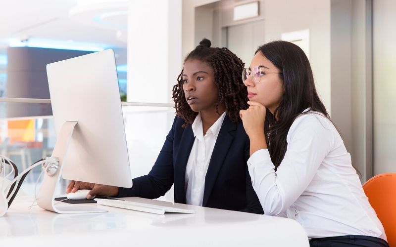 Co-workers looking at a computer together