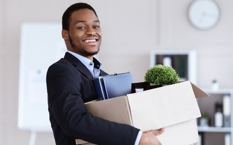 Young business man happy to pack up his office