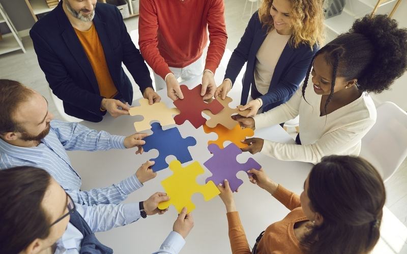 Group of people holding a puzzle