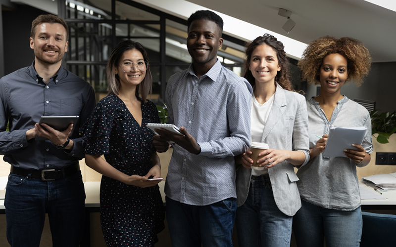 5 people standing and smiling