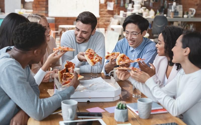 Group of people eating pizza