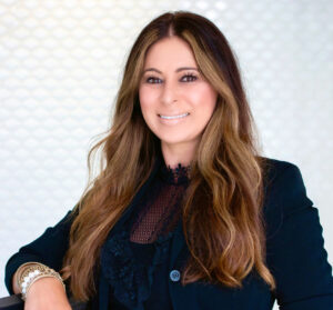 Woman wearing a black blazer smiling