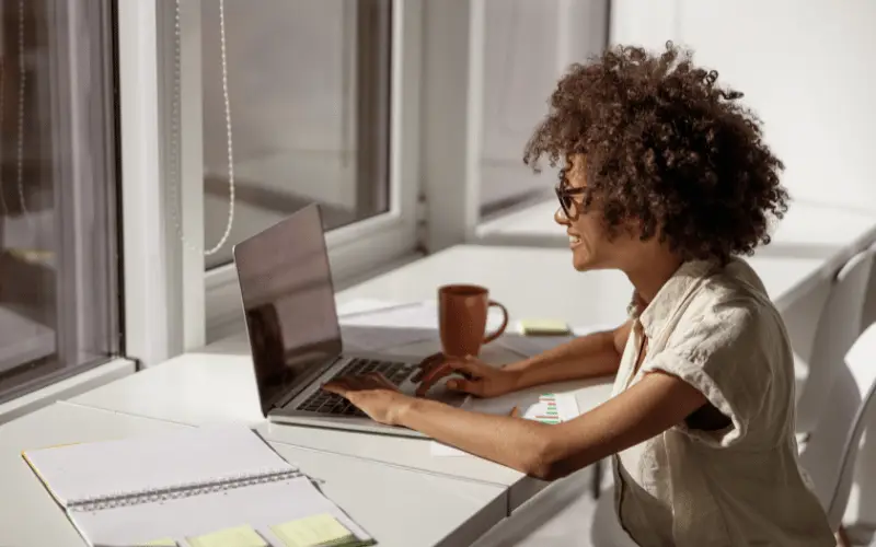 woman working at her laptop in a sunny office